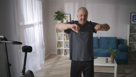 morning-exercise-of-middle-aged-man-in-living-room-person-is-stretching-arms-breathing-exercise-healthy-lifestyle-keeping-fit